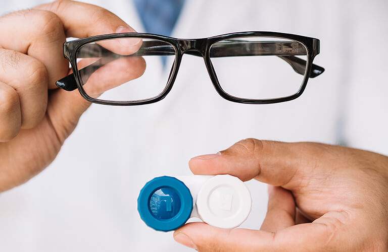 male-doctor-showing-pair-black-glasses-contact-lens